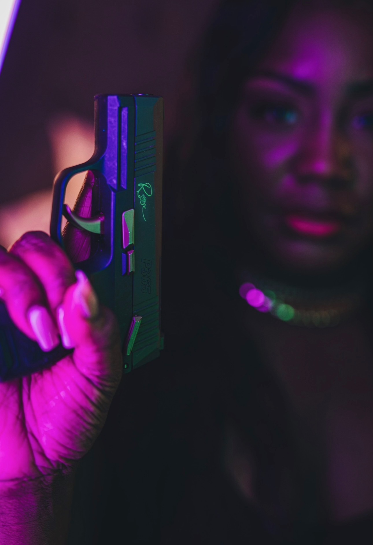 Woman holding a pistol with calm, mindful confidence